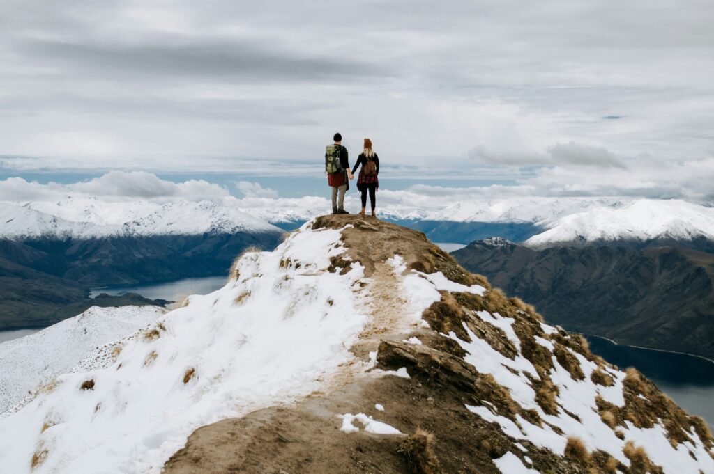 Image of a couple on top of a snowy mountain, looking out at the landscape | SAP and IBM