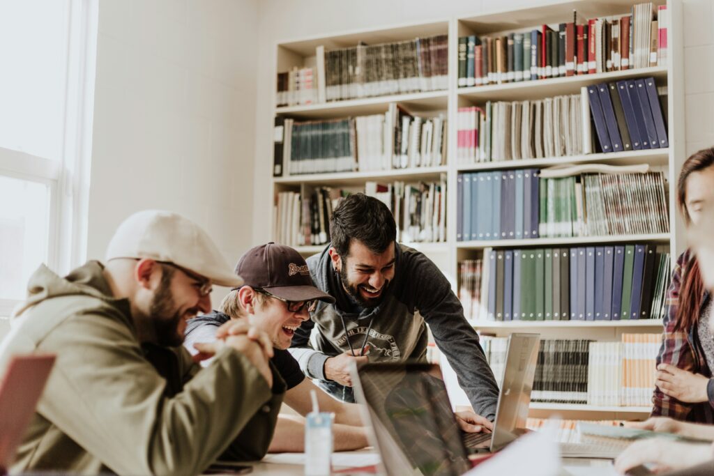 photo of a group of people in the office looking at a laptop and laughing | Google Cloud and Stagwell AI collaboration