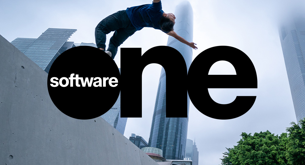 a software one logo on a background of tall urban buildings | SoftwareOne admits “disappointing” Q3 24 results amid strategy change