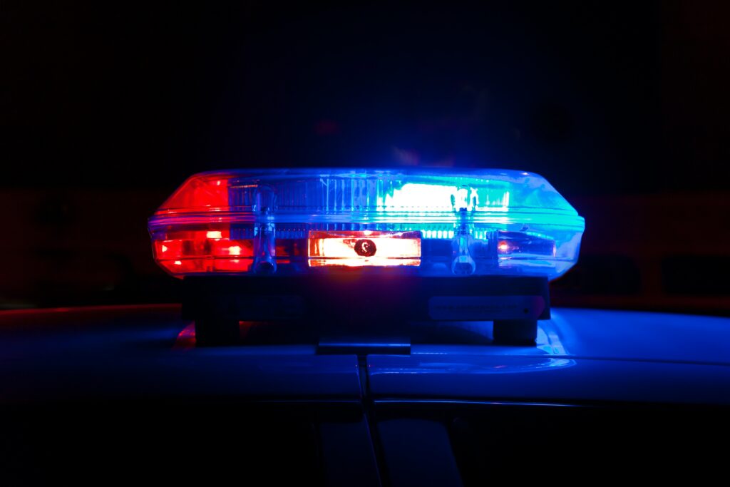 A close up of a police siren, typically found on top of most police vehicles, it's red and blue and in front of a dark background | Norwegian Police IFS