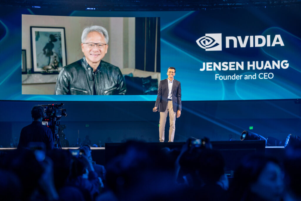 Snowflake CEO Sridhar Ramaswamy on a conference stage next to a screen showing NVIDIA CEO Jensen Huang | Snowflake pioneers customized AI Applications with NVIDIA