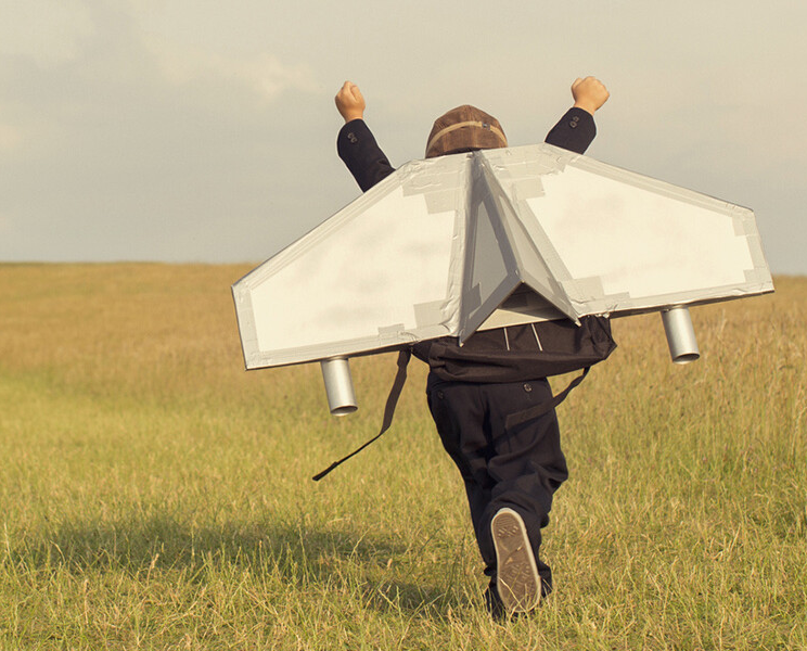 Kid pretending to fly with a spaceship on his back : SAP TechEd